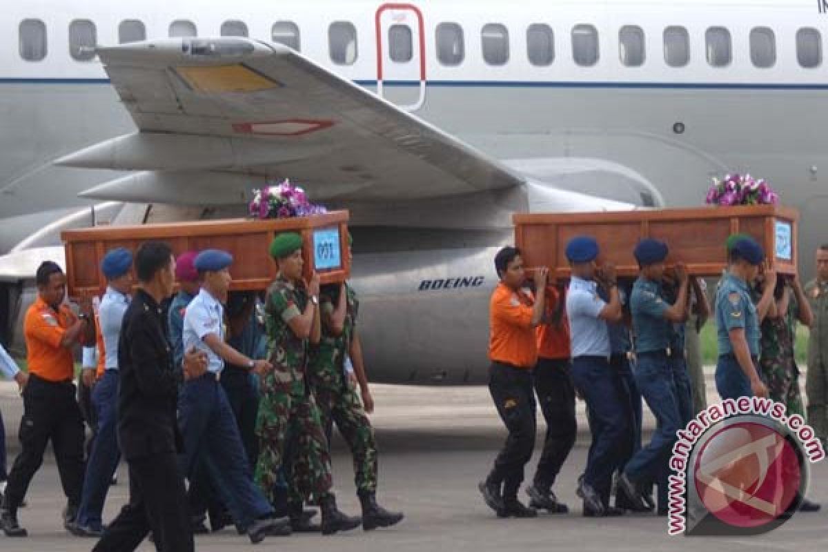 Bodies of two AirAsia plane crash victims being identified