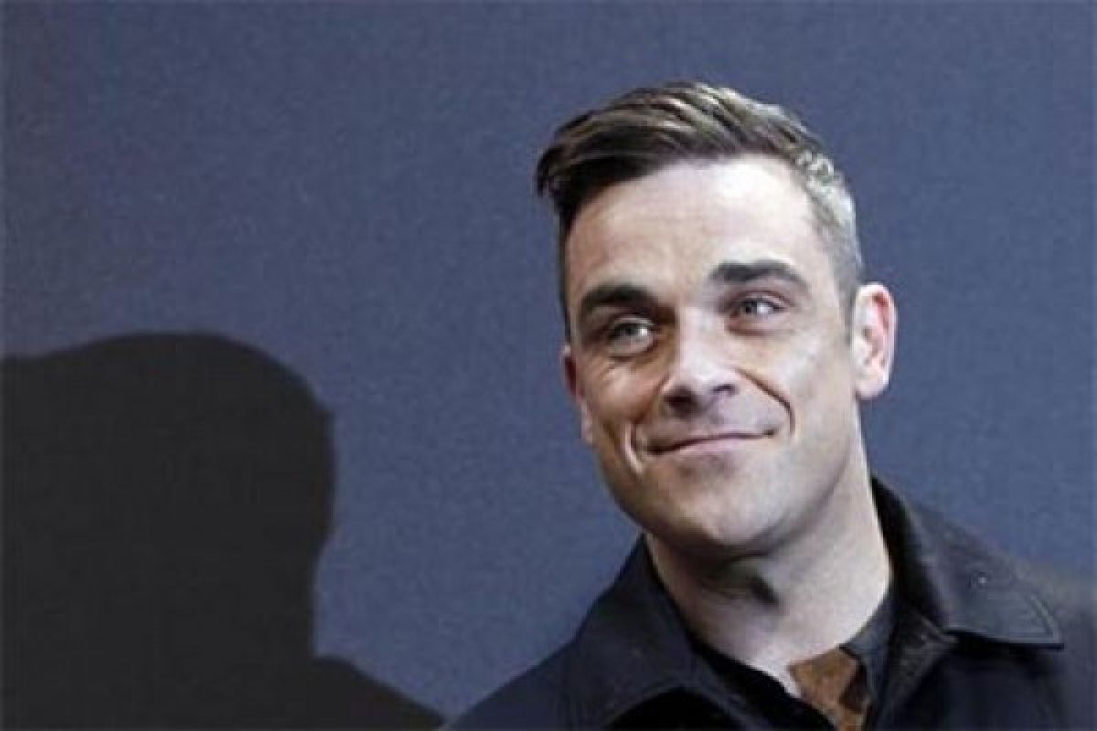 Robbie Williams tidak bisa ikut reuni Take That dalam waktu dekat