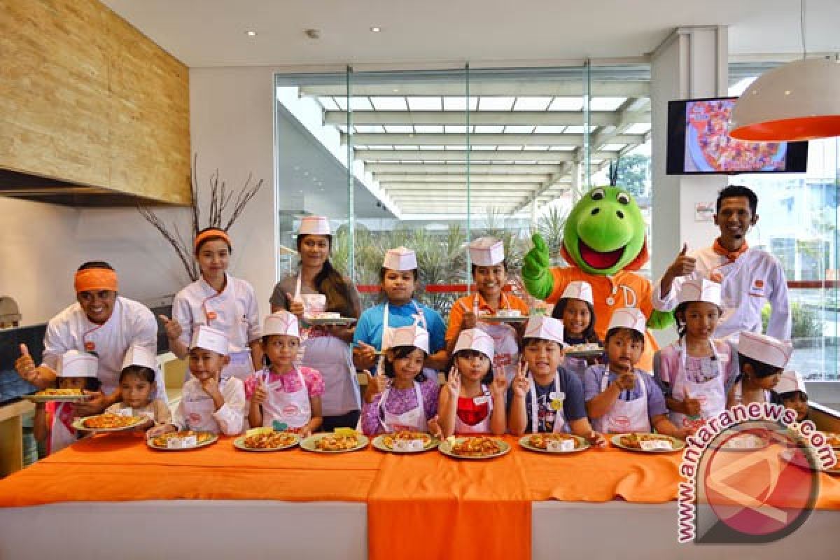 Cheerful Expression of Junior Chef during Kids Cooking Class at HARRIS-POP! Hotels & Conventions Denpasar