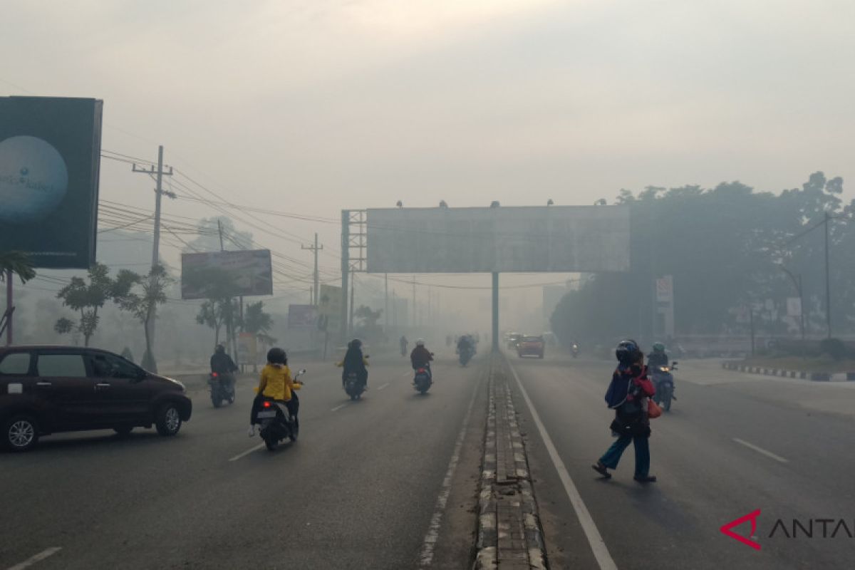 Thick smoke blankets Banjarbaru