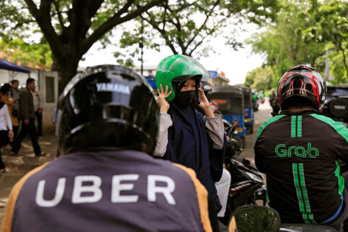 Grab dan Uber didenda karena lakukan merger