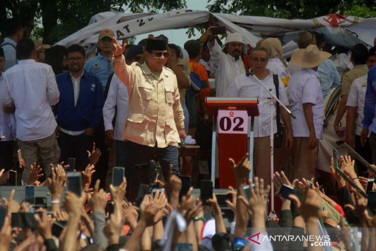 Prabowo Subianto greets journalists covering his campaign in Karawang