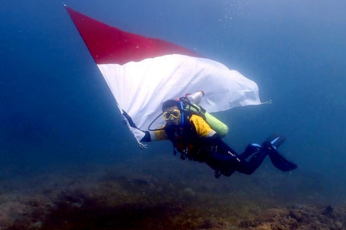 Amman Mineral kibarkan bendera dan pasang terumbu karang di bawah laut