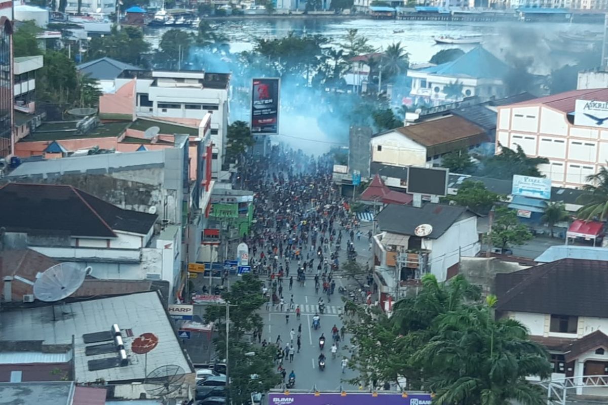 Security personnel fire tear gas to diffuse rioters in Papua