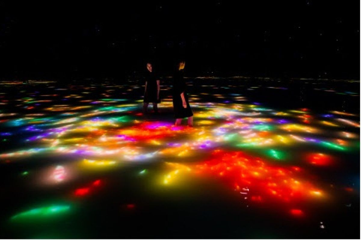 teamLab Planets, a museum where you move through water in Toyosu, Tokyo, is currently a space for autumn. the carp swimming on the water’s surface change into autumn leaves when they collide with visi