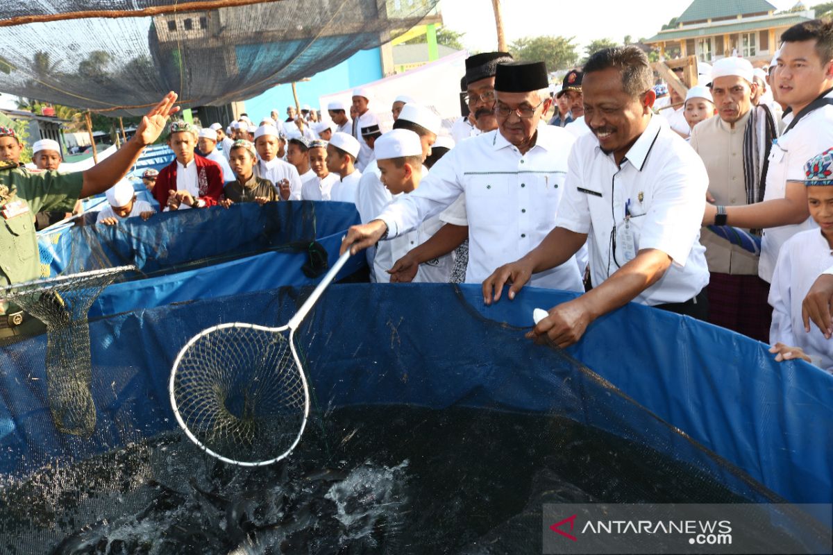 Banjar Regent and santri harvest lele