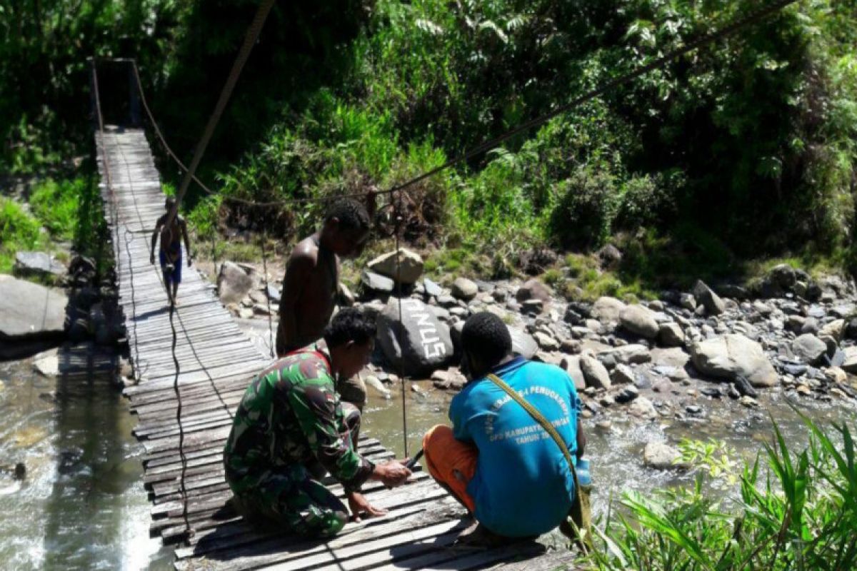 Babinsa Koramil Jila bersama warga kerja bakti perbaiki jembatan gantung