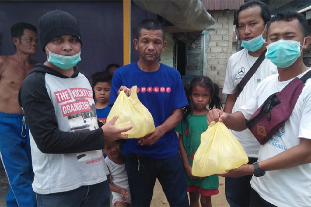 Relawan SR bagi-bagi cairan disinfektan kepada warga Karimun