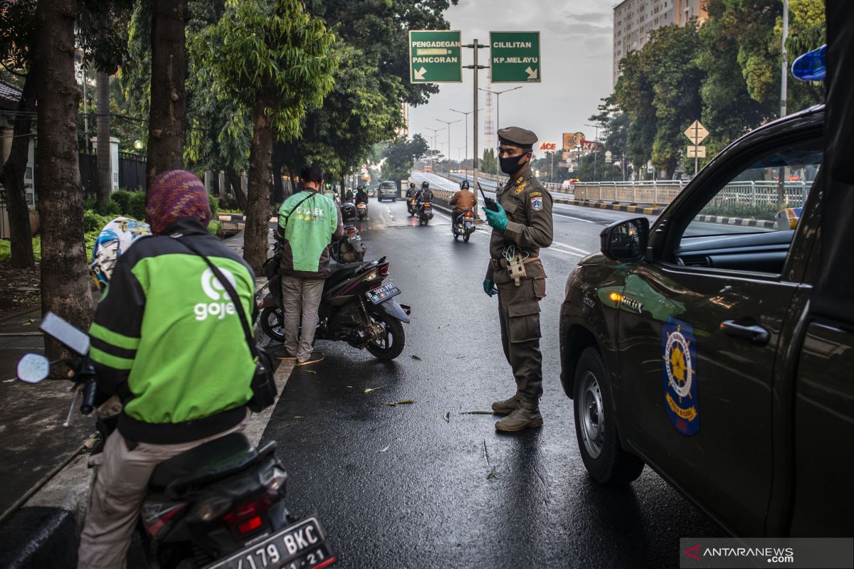 Ojek taxi driver is on the road amid Jakarta restrictions