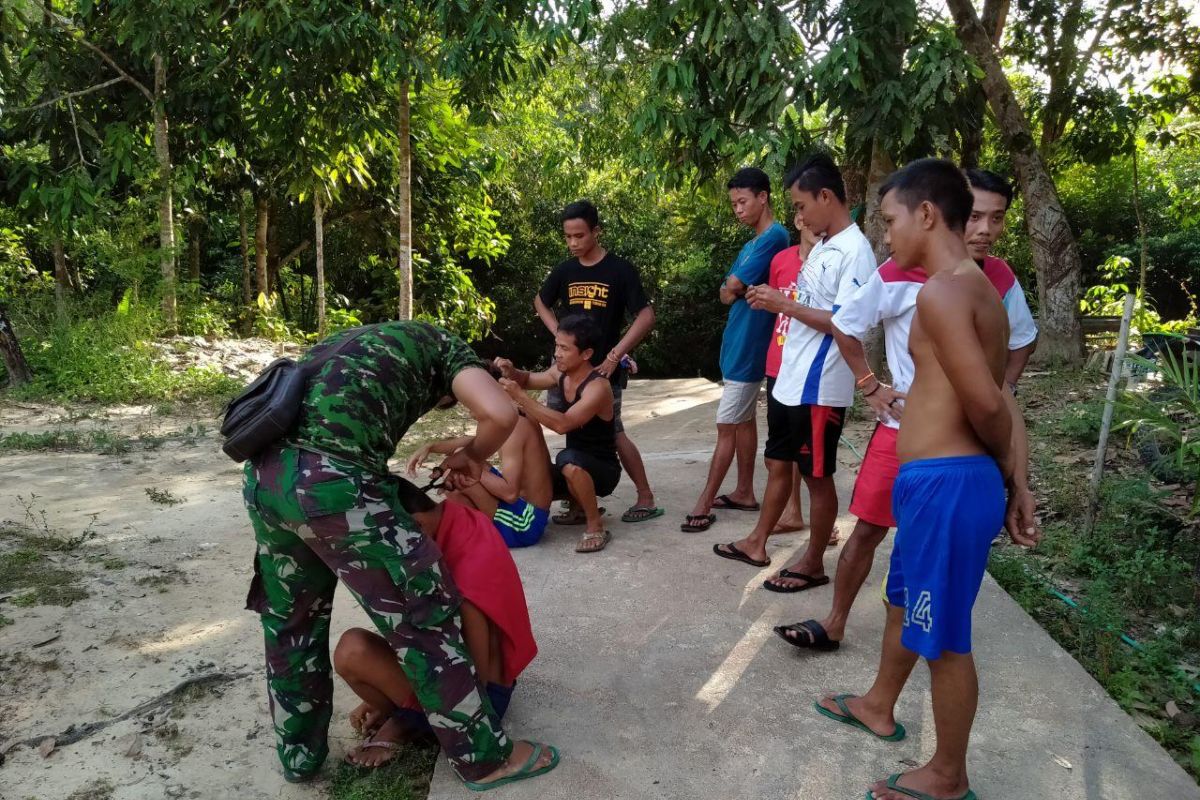 Pemuda Dusun Sekura, potong rambut gratis dengan prajurit TMMD
