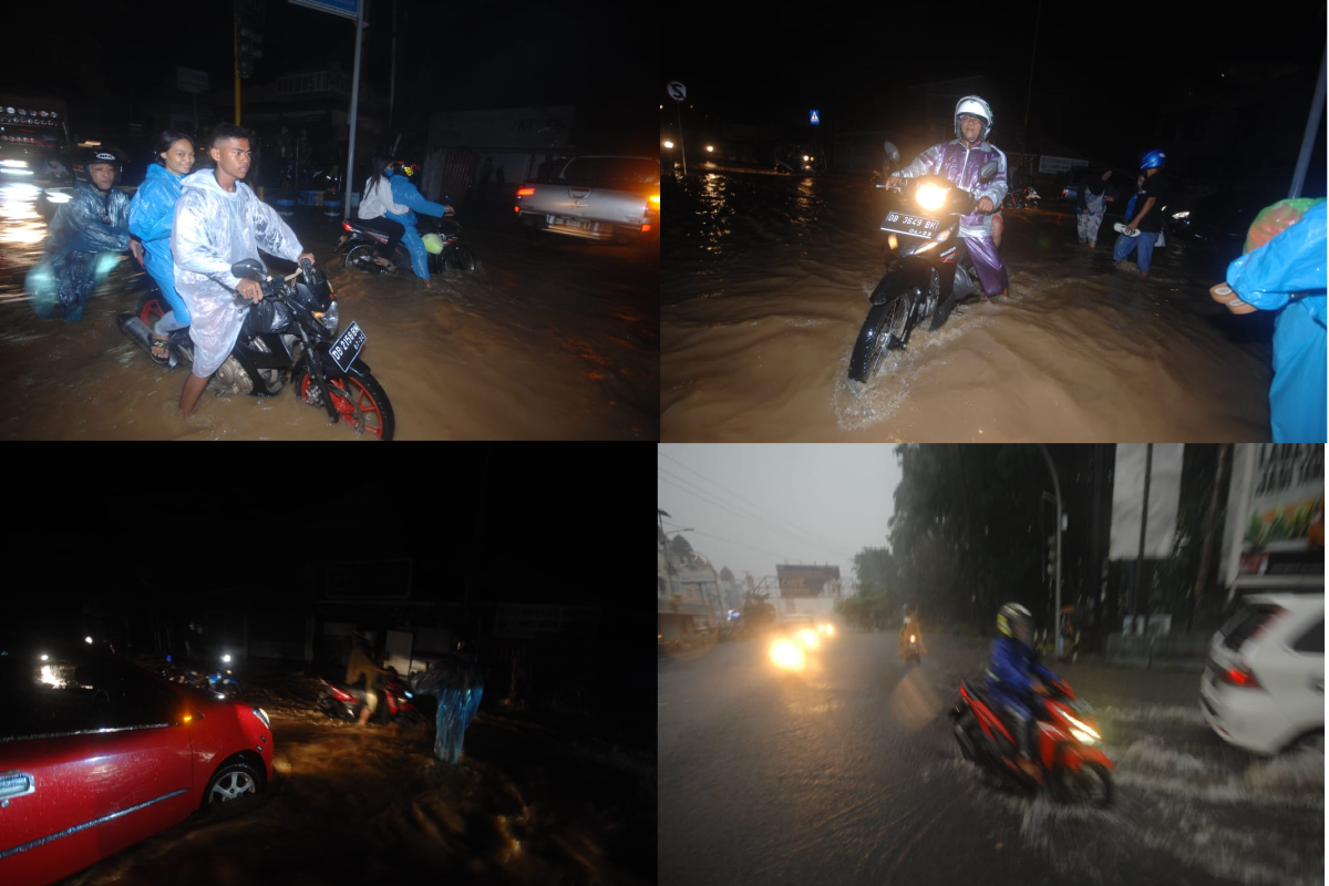 Pengendara menerobos banjir di jalan utama Kota Manado