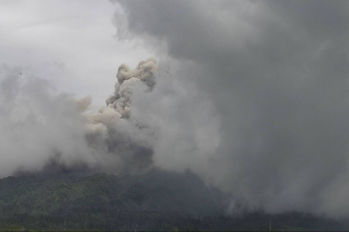 Mount Merapi spews hot clouds rising two kilometers above crater