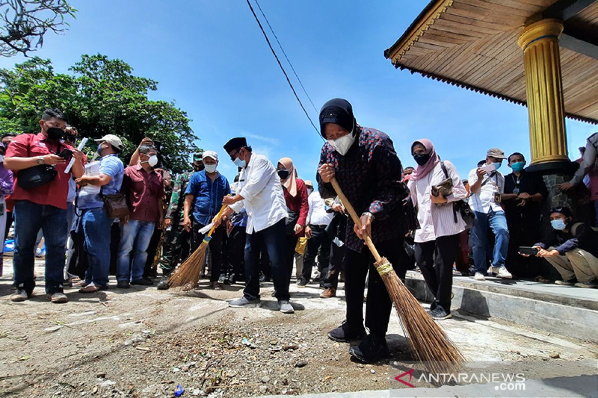 Mensos sapu halaman Makam Syekh Burhanuddin Padang Pariaman