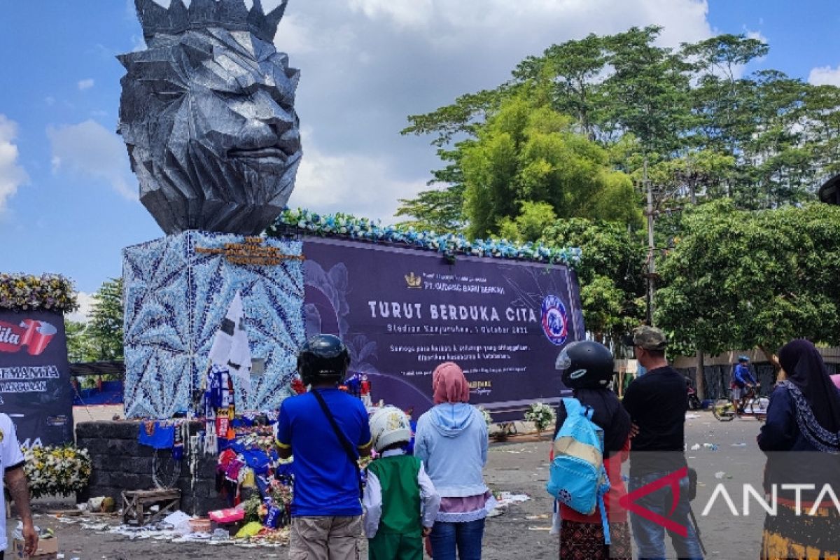 Puluhan orang berdoa di depan Patung Singa untuk korban tragedi Kanjuruhan