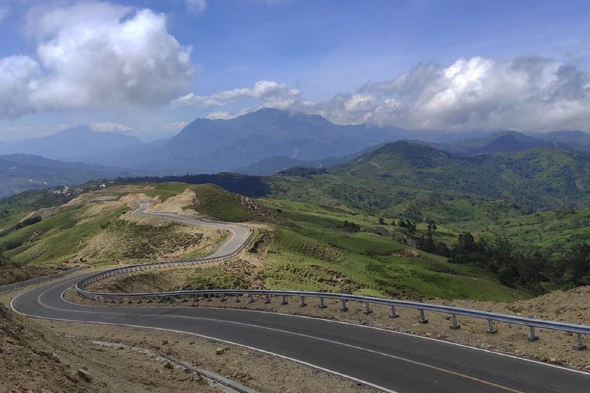 Melintasi jalan Sabuk Merah di perbatasan Indonesia-Timor Leste yang dikeliling bukit