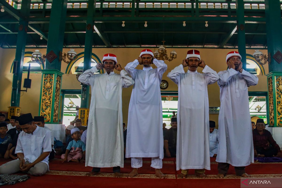 Tiba di masjid saat adzan, harus berdiri atau boleh duduk?