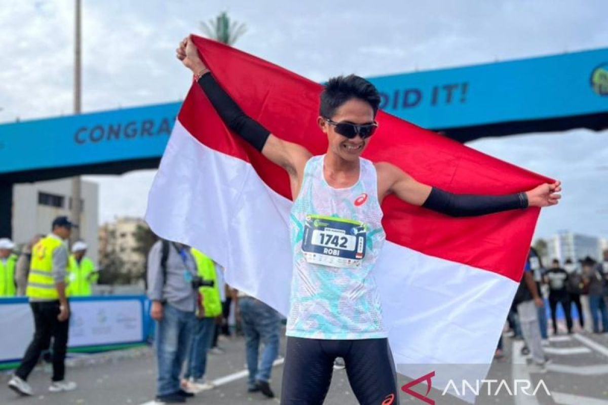 Robi Syianturi dan Megawati pembawa bendera dalam defile SEA Games