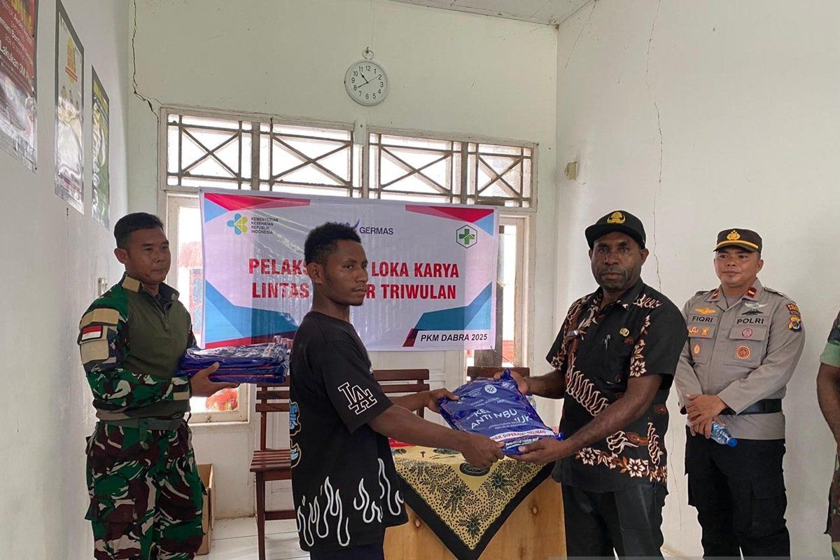 Prajurit TNI Satgas Yonif 511/DY membagikan kelambu kepada warga Papua