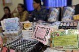 Denpasar (Antara Bali) - Tiga petugas Balai Besar Pengawasan Obat dan Makanan (BBPOM) Denpasar menggelar barang sitaan berupa berbagai merk obat-obatan dan kosmetika yang mengandung zat berbahaya di Denpasar, Bali, Jumat (23/9).  Sebanyak 14.468 kemasan dari berbagai merk obat dan kosmetika disita dari penjual karena selain mengandung zat berbahaya juga tidak memiliki izin edar bahkan beberapa produk diantaranya merupakan barang palsu. FOTO ANTARA/Nyoman Budhiana/11.