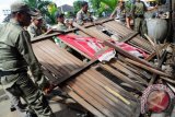 Sejumlah anggota Satpol PP Kota Pontianak merobohkan dinding lapak Pedagang Kaki Lima (PKL), saat melakukan penertiban di Jalan Alianyang, Pontianak, Kalbar, Selasa (10/4). Secara berkesinambungan Satpol PP melakukan penertiban PKL di sejumlah titik kota, guna menciptakan Pontianak yang bersih dan rapi. FOTO ANTARA/Jessica Helena Wuysang/12