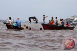 Sejumlah warga Tionghoa bermain air saat melaksanakan tradisi mandi U-Shi atau mandi tengah hari, di Sungai Kapuas, Pontianak, Kalbar, Sabtu (23/6).