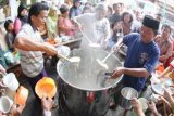 Solo (Antara Bali) - Sejumlah petugas membagikan bubur Samin Banjar secara gratis kepada masyarakat untuk berbuka puasa di Masjid Darussalam, Solo, Jateng, Senin (23/7). Tradisi itu sudah dimulai sejak tahun 1930 untuk kalangan terbatas, namun sejak tahun 1985 mulai dibagikan kepada masyarakat luas dengan menghabiskan 40kg beras untuk 900 porsi per hari selama Bulan Ramadan. FOTO ANTARA/Akbar Nugroho Gumay/2012.