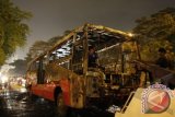 Petugas melakukan evakuasi sebuah Bus Transjakarta bernomor polisi B 7741 IS yang terbakar di Jalan Sudirman, Kawasan Semanggi, Jakarta, Senin malam (5/11). Kejadian tersebut disebabkan oleh korsleting arus listrik pada mesin Bus dan tidak ada korban jiwa dalam kejadian tersebut. FOTO ANTARA/Reno Esnir/ed/ama/12.