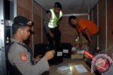Sejumlah anggota polisi melakukan pemeriksaan muatan pada truk boks ketika operasi cipta kondisi pada kendaraan yang melintas di kawasan Jalan Ahmad Yani, Surabaya, Jatim, Jumat (28/6) malam. Operasi tersebut untuk meningkatkan keamanan dan ketertiban menjelang Bulan Ramadhan serta sebagai antisipasi hilangnya 250 batang dinamit. ANTARA FOTO/M Risyal Hidayat/Koz/nz/13.