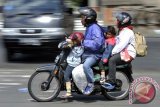 Sepasang pemudik bersepeda motor mengangkut anak dan barang bawaan di Pelabuhan Gilimanuk, Jembrana, Bali, Senin (5/7). Meski telah dihimbau bagi pemudik bersepeda motor untuk tidak mengangkut orang dan barang melebihi kapasitas namun sejumlah pemudik tetap tidak memperhitungkan keselamatan. ANTARA FOTO/Nyoman Budhiana/nym/2013.