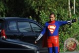 Polantas berpakaian superhero ketika mengatur arus lalu lintas di Padangpariaman, Sumbar, Jumat (10/1). Sejumlah anggota Satlantas Polres Padangpariaman berpakaian karakter fiksi seperti Superman dan Wonderwoman untuk menarik perhatian anak-anak dan remaja sehingga lebih peduli terhadap keselamatan berlalu lintas. ANTARA FOTO/Iggoy el Fitra/Koz/Spt/14.