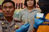 Madiun (Antara Jatim) - Kapolres Madiun AKBP Rakhmad Setiadi (kanan) menunjukkan tersangka dan barang bukti gelang emas palsu di Mapolres Madiun, Jawa Timur, Jumat (28/3). Polres Madiun menangkap tersangka penipuan AR (41), usai menggadaikan 33 gram gelang emas senilai Rp9,6 juta di Pegadaian UPC Caruban, yang ternyata emas palsu. FOTO Fikri Yusuf/14/DK

