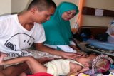 Dengan penuh perhatian dan kasih sayang, Ketua GOW Kota SIngkawang, Ny. Hj. AGustina Abdul Muthalib, mengelus Julian (2 tahun) pasien Rumah Sakit Abdul Azis, yang mengidap penyakit Hydrochephallus, Minggu (27/4). Kegiatan ini dilakukan dalam rangka Peringatan Hari Kartini tahun 2014. Foto MC Singkawang