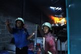 Tulungagung (Antara Jatim) - Petugas pemadam kebakaran memberi aba-aba dalam upaya mereka memadamkan api yang membakar sebuah gudang penyimpan aneka plastik di Kelurahan Bago, Kabupaten Tulungagung, Jawa Timur, Rabu (14/5). Pemilik gudang menengarai adanya unsur sabotase dalam insiden yang dialaminya, menyusul upaya pembakaran serupa oleh orang tertentu pada sepekan sebelumnya. Kasus tersebut saat ini masih diselidiki pihak kepolisian. Foto Destyan Handri Sujarwoko/14/Chan.