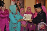 Ketua Dewan Kerajinan Nasiona Daerah (Dekrasda) Provinsi Jambi Hj Yusniana Hasan Basri sedang memperhatikan piagam penghargaan yang diterima Stan Dekranas Provinsi Jambi pada HUT Dekranas di Jakarta