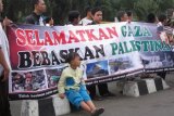 Kediri (Antara Jatim) - Sejumlah massa dari organisasi Islam di Kediri, Jawa Timur, unjuk rasa mendukung pembebasan Palestina di alun-alun Kota Kediri, Minggu (13/7). Massa menyesalkan agresi Israel ke Jalur Gaza yang mengakibatkan puluhan warga sipil, terutama anak-anak menjadi korban. (FOTO Asmaul Chusna/14/edy)