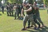 Sejumlah prajurit United States Marines Corps (USMC), bersama prajurit Korps Marinir TNI AL mengikuti permainan tradisional Indonesia Lomba Lari Bakiak di sela-sela latihan bersama Marines Tactical Warfare Simulation (MTWS)-14, di Brigade Infanteri-1 (Brigif-1) Marinir Gedangan, Sidoarjo, Sabtu (13/9). Latihan bersama MTWS-14 antara Korps Marinir TNI AL dan USMC yang digelar hingga 18 September 2014 dan diikuti 33 personel USMC tersebut, merupakan latihan untuk mengasah kemampuan dan ketrampilan dalam penanggulangan bencana dan Operasi Militer Selain Perang (OMSP). ANTARA FOTO/Eric Ireng/ed/mes/14