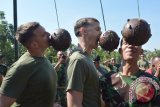 Sejumlah prajurit United States Marines Corps (USMC), bersama prajurit Korps Marinir TNI AL mengikuti permainan tradisional Indonesia Lomba Gigit Uang di sela-sela latihan bersama Marines Tactical Warfare Simulation (MTWS)-14, di Brigade Infanteri-1 (Brigif-1) Marinir Gedangan, Sidoarjo, Sabtu (13/9). Latihan bersama MTWS-14 antara Korps Marinir TNI AL dan USMC yang digelar hingga 18 September 2014 dan diikuti 33 personel USMC tersebut, merupakan latihan untuk mengasah kemampuan dan ketrampilan dalam penanggulangan bencana dan Operasi Militer Selain Perang (OMSP). ANTARA FOTO/Eric Ireng/ed/mes/14