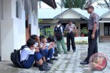 Polisi memberikan arahan kepada sejumlah pelajar bolos yang terjaring razia di wanter pada jam pelajaran di Polsek Lueng Bata, Banda Aceh, Senin (27/10). Sebanyak 12 pelajar SMK,SMA.SMP dan SD terjaring di warnet karena bolos pada jam pelajaran diamankan polisi dan kemudian diserahkan kepada masing-masing pihak sekolah untuk pembinaan. ANTARAACEH.COM/Ampelsa/14