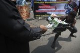 Aktivis yang tergabung dalam Aliansi Masyarakat Anti Korupsi (SIMAK) dan Konsorsium Masyarakat Untuk Kudus Bersih (KMKB) melakukan teatrikal saat aksi demonstrasi memperingati Hari Anti Korupsi se-Dunia di Alun-alun Kudus, Jateng, Selasa (9/12). Dalam aksi memperingati Hari Antri Korupsi se-Dunia yang jatuh pada tanggal 9 Desember itu mereka mendesak keadilan dan penegakan hukum di Indonesia dilakukan tanpa diskriminasi dan tebang pilih.ANTARA FOTO/Andreas Fitri Atmoko/ss/pd/14.