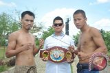 Petinju Indonesia asal Kalbar, Daud Cino Yordan (kanan) dan Petinju Filipina Ronald Pontillas usai timbang badan untuk memperebutkan gelar juara kelas ringan di Tugu Khatulistiwa, Pontianak, Kalbar, Jumat (19/12). Daud Yordan akan berhadapan dengan Ronald Pontillas pada perebutan gelar juara kelas ringan WBO Asia Pasifik di Pontianak, Kalbar pada Sabtu (20/12) malam. ANTARA FOTO/Jessica Helena Wuysang
