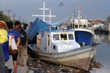 Sejumlah warga melihat dari dekat kapal KM 6633 J.5.NO.905 XX yang digunakan untuk membawa sabu usai dilakukan penggeledahan oleh Badan Narkotika Nasional (BNN) di Dermaga Dadap, Kabupaten Tangerang, Banten, Selasa (6/1). Badan Narkotika Nasional (BNN) melakukan penggeledahan dalam kapal yang dijadikan tempat menaruh dan mengangkut sabu seberat 800kg dari tengah laut.ANTARA FOTO/Muhammad Iqbal/pd/15