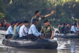 Surabaya (Antara Jatim) - Panglima TNI, Jenderal TNI Moeldoko melambaikan tangan disela-sela kegiatan bersih-bersih kali Surabaya, Jatim, Sabtu (21/2). Kegiatan yang diikuti 21 ribu anggota TNI dan Polri bersama warga Surabaya tersebut guna membersihkan dari sampah sepanjang kali Surabaya. FOTO HO-MRH/EI/15