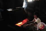Pekerja menggonseng kopi saat proses pengolahan menjadi bubuk kopi di Industri Kopi Keutapang Dua, Kecamatan Darul Imara, Aceh Besar, Aceh, Rabu (15/4). Bubuk kopi yang diproduksi secara tradisional dan menggunakan bahan bakar kayu itu, permintaannya masih tinggi karena memiliki khas tersendiri dengan harga jual untuk jenis bubuk kopi super seharga Rp75.000 perkilo. ANTARAACEH.COM/Ampelsa/15 