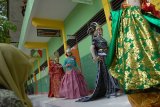 Jombang (Antara Jatim) - Pelajar memperagakan busana adat di depan kelas saat fashion show putri Bhineka di Madrasah Aliyah Negeri (MAN) Jombang, Jawa Timur, Rabu (29/4). Fashion show pakaian adat itu dalam rangkah perayaan kelulusan serta peringatan HUT MAN Jombang ke-24. Menurut Kepala sekolah tersebut Syamsul Ma'arif dipilihnya baju adat itu sebagai jawaban atas terkikisnya budaya leluhur di kalangan pelajar. Apalagi, sejak dua pekan terakhir ini ada kabar perayaan kelulusan dengan pesta bikini. foto Syaiful Arif/15/Chan.