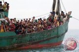 Imigran suku Rohingya dari Myanmar berada di perhu mereka yang terdampar di perairan Desa Simpang Tiga, Kecamatan Julok, Aceh Timur, Aceh, Rabu (20/5). Sebanyak 400 Imigran itu terdampar dan ditemukan nelayan Aceh sekitar 26 mil dari pesisir pantai Desa Simpang Tiga. ANTARA FOTO/Syifa/Irp/Rei/Spt/15.