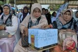 Warga memberikan infaq atau sedekah dalam aksi penggalangan dana untuk pengungsi etnis Rohingya, Myanmar, saat berlangsung rapat akbar Hizbut Tahrir di standion Hadimurthala, Banda Aceh, Aceh, Minggu (24/5). Penggalangan dana kemanusiaan terus meluas di Aceh, untuk membantu sekitar 1.000 lebih etnis Rohingya dan Bangladesh yang terdampar di Aceh. ANTARA FOTO/Ampelsa/ss/Spt/15