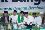 Ketum Partai Kebangkitan Bangsa (PKB) Muhaimin Iskandar (ketiga kiri) berbincang bersama Ketum PBNU Said Aqil Siraj (kedua kanan) saat menghadiri acara "Sholawat dan Tahlil Untuk Bangsa" di Kantor DPP PKB, Jakarta, Selasa (23/6). Acara yang diadakan dalam rangka bulan suci Ramadan itu diikuti oleh 3000 umat Islam dari berbagai daerah di Indonesia dengan tema "Sejukan Indonesia Dengan Bersholawat". ANTARA FOTO/Muhammad Adimaja/Asf/foc/15.
