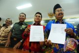 Ketua Majelis Ulama Indonesia (MUI) Kalbar, KH Hasyim Dahlan (kanan) dan Sekretaris Persatuan Gereja Indonesia (PGI) Wilayah Kalbar, Pendeta F Deman Sukardi (dua kanan) memperlihatkan surat deklarasi damai, didampingi Kasdam XII/Tanjungpura, Brigjen TNI Aris Martono (dua kiri) serta Ketua Forum Kerukunan Umat Beragama (FKUB) Kalbar, Ignatius Lyong (kiri), usai gelar pertemuan di Makodam XII/Tanjungpura, Kabupaten Kubu Raya, Kalbar, Rabu (22/7).  Dalam pertemuan tersebut, para tokoh agama Kalbar menyerukan kepada masyarakat Kalbar untuk tetap bersatu dan menolak segala bentuk provokasi terkait isu SARA yang marak beredar terutama di media sosial, pasca insiden yang terjadi di Tolikara, Papua pada Jumat (17/7) lalu. ANTARA FOTO/Jessica Helena Wuysang/15