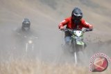 Sejumlah pengendara motor trail dari Krackers Indonesia melintas di lautan pasir Taman Nasional Bromo Tengger Semeru, Probolinggo, Jawa Timur, Senin (17/8). Dalam Taman Nasional Bromo Tengger Semeru tersebut menyajikan pemandangan Gunung Bromo yang berada di jajaran gunung Batok dan gunung Semeru berada di hamparan lautan pasir seluas 10 kilometer persegi tersebut menyajikan trek alami bagi penggemar olahraga motor trail. Antara Jatim/M Risyal Hidayat/15