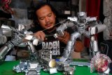 Perajin membuat miniatur robot berkarakter tokoh Transformer dengan bahan limbah sabuk dan logam di Anjasmoro Tengah, Karangayu, Semarang, Jawa Tengah, Senin (14/9). Kerajinan berharga Rp20.000 hingga Rp1 juta tersebut dipasarkan secara online ke sejumlah daerah di Indonesia. ANTARA FOTO/Aditya Pradana Putra/wdy/15.